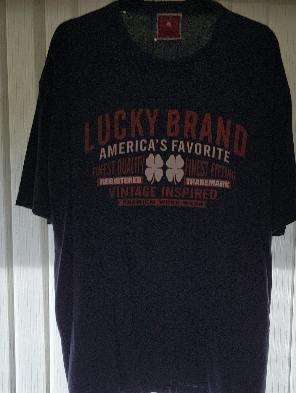 Lucky Brand Men’s Black Tee with Red Graphic and Cream Clover